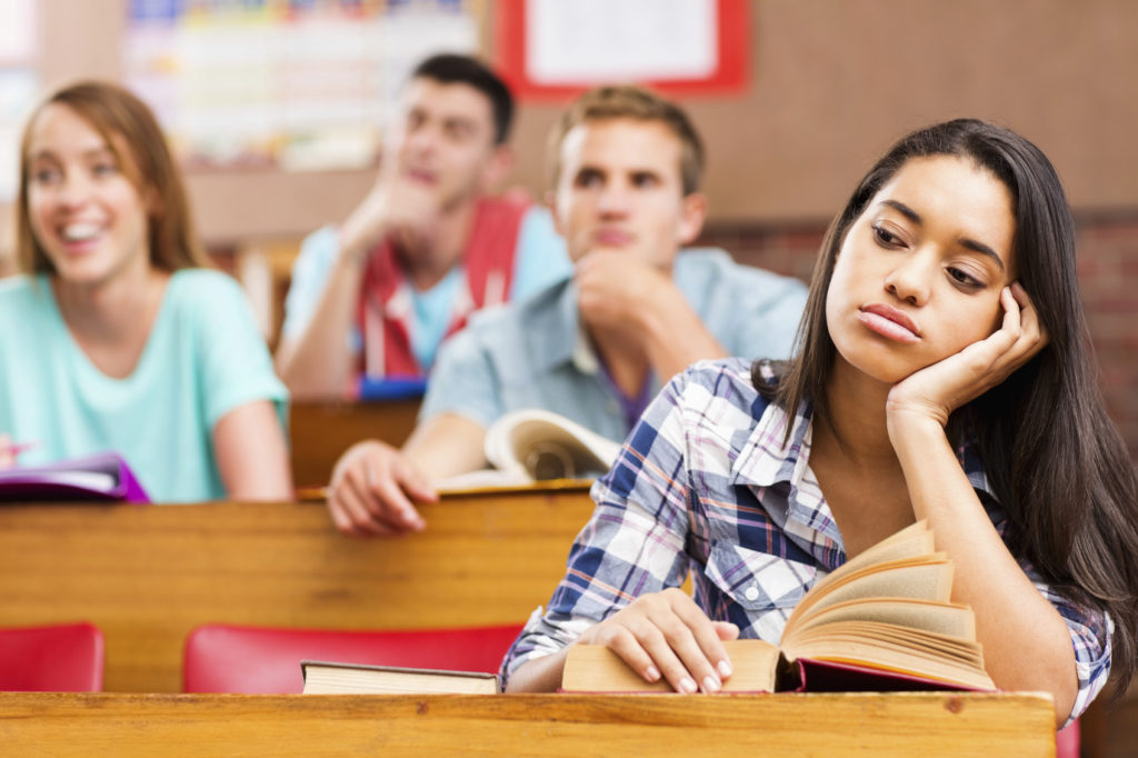 bored-student-at-desk-with-classmates-in-background-wells-fargo-blogs