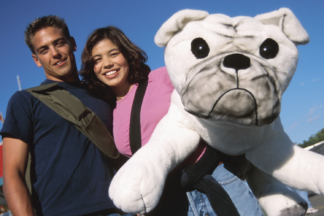 Couple at a carnival holding a stuffed dog