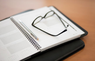 Image of desk calendar and reading glasses