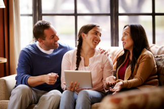 Parents sitting with their college age student